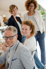Office workers talking and smiling at meeting