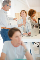 Fototapeta premium Office workers talking at desk