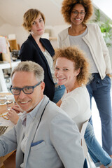 Fototapeta premium Office workers talking and smiling at meeting