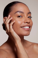 Portrait of young woman touching face
