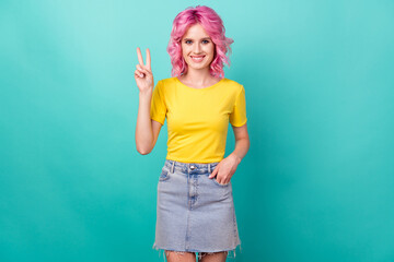Photo of young funny pink hairdo lady show v-sign wear yellow t-skirt isolated on teal background