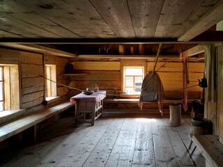 A room in an old wooden house. Wooden floor and ceiling in an old house.