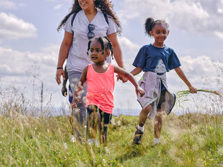 Mother with two kids hiking in nature © Cultura Creative