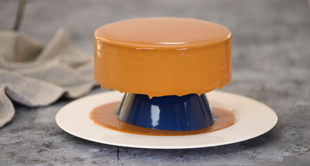 Caramel mousse cake covered with mirror glaze.