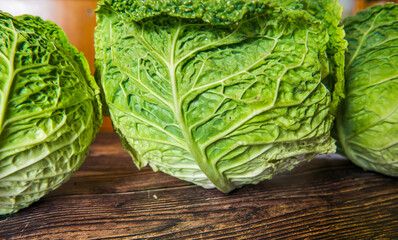 Fresh bio green garden cabbage on rustic wooden background from farm village gardening.