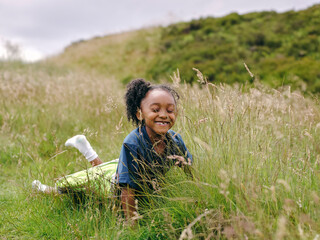 Smiling girl lying in grass