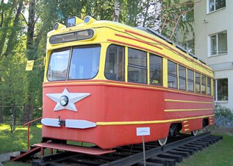 Fototapeta na wymiar An old soviet tram. Red-yellow Soviet tram. 