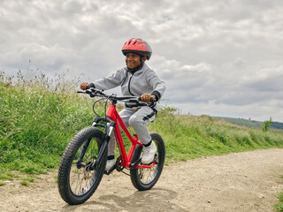 Fototapeta na wymiar Boy riding bicycle in countryside