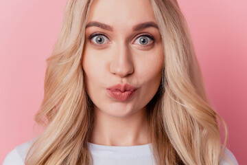 Portrait of romantic blonde adorable lady send air kiss on pink background