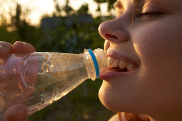 cheerful woman drinking water nature sun thirst