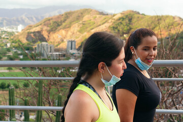 Women talking without protective mask while training in the city