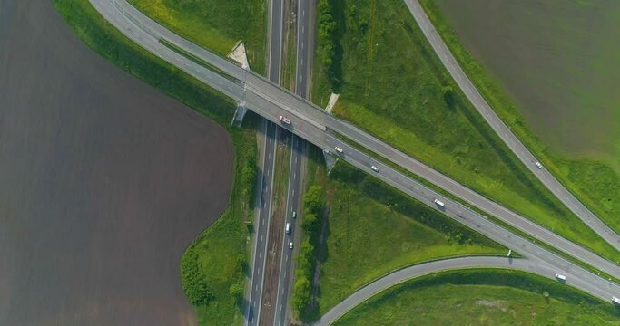 Traffic interchange top view. Ato go on the highway top view. Flying over a road junction. Cars drive along the highway outside the city