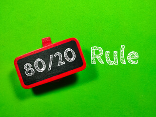 Business concept.Text 80 and 20 Rule writing on colored wooden board on green background.