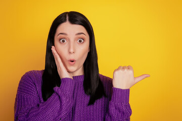 Portrait of young girl amzed shocked indicate thumb empty space adver promo select isolated over...