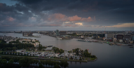 Aerial view of the city of Amsterdam, capital of the Netherlands on a calm summer evening, during cloudy sunset
