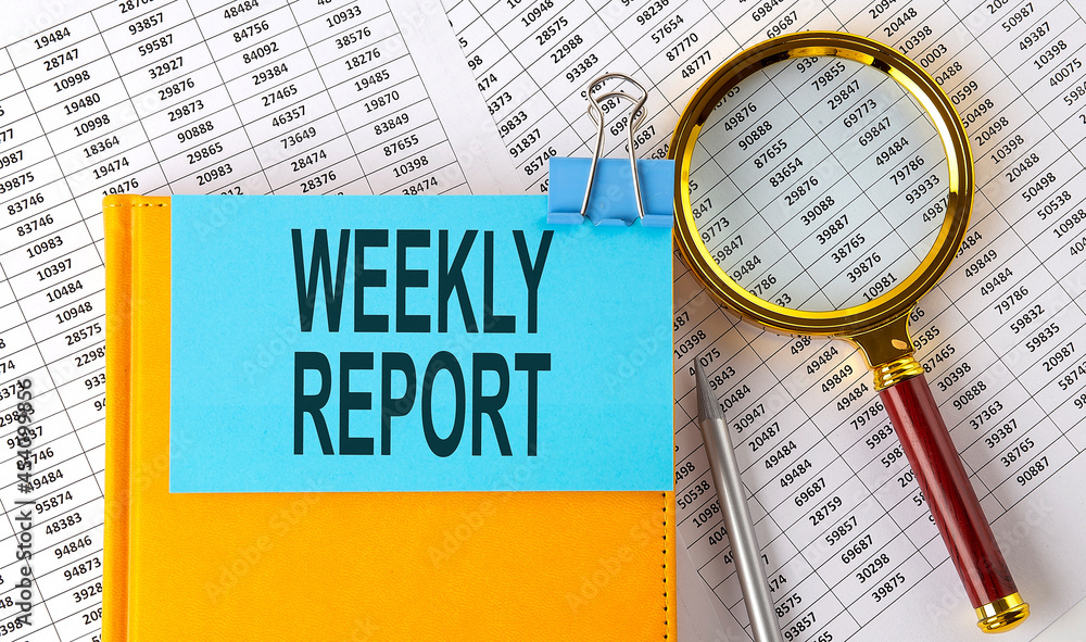 Poster weekly report text on sticker on notebook with magnifier and chart. business concept