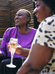Two women relaxing in backyard