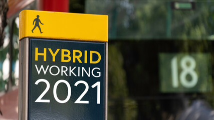 Hybrid Working 2021 sign in a busy commuter city center