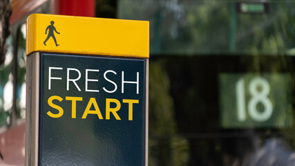 Fresh Start sign in a busy commuter city center