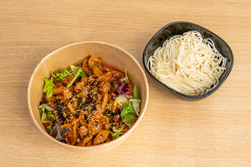 Korean Yeyuk served in a home delivery bowl with udon noodles