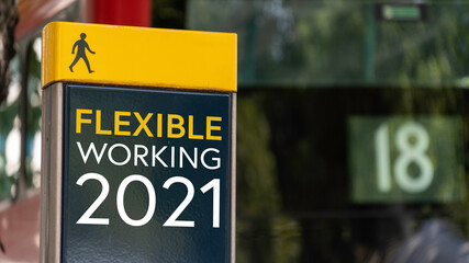 Fototapeta premium Flexible Working 2021 sign in a busy commuter city center