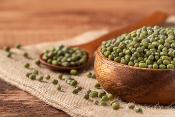 Close up of raw mung bean on wooden table background.