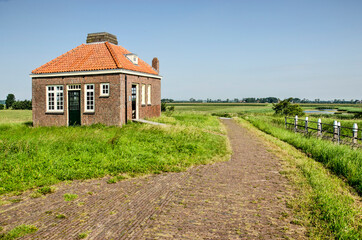Schokland, The Netherlands, August 12, 2021: the little fog horn building on the northernmost mound of the former island