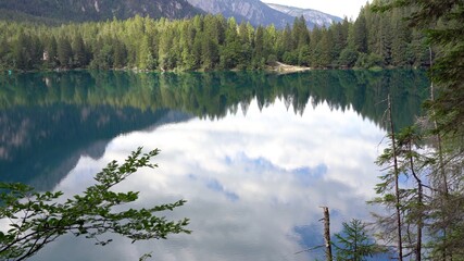 Europe, Italy, Trentino, Dolomites italian Alps mountains - Tovel lake, Lago di Tovel with green water and pines forest during the summer - sand beach  