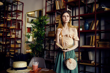 cheerful woman reading a book in a cafe recreation