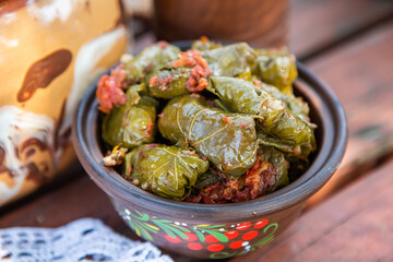 Dolma.Traditional romanian cuisine stuffed cabbage leaves with minced meat and rice in ceramic dish.