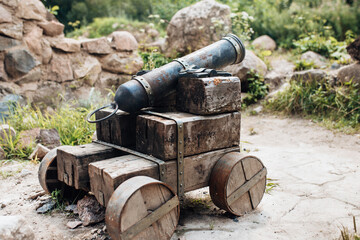 Ancient cannon with a cast iron barrel for shooting cannonballs - weapon reconstruction