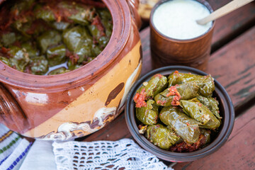 Dolma.Traditional romanian cuisine stuffed cabbage leaves with minced meat and rice in ceramic dish.