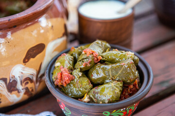Dolma.Traditional romanian cuisine stuffed cabbage leaves with minced meat and rice in ceramic dish.