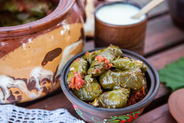 Dolma.Traditional romanian cuisine stuffed cabbage leaves with minced meat and rice in ceramic dish.