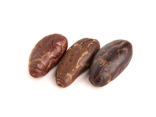 Close up of three refined cacao grains isolated
