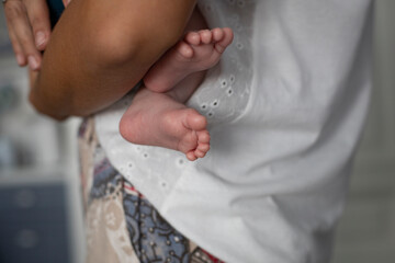 Mom holds baby  in her arms