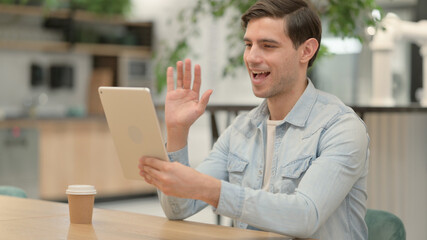 Young Man making Video Call on Tablet at Work 