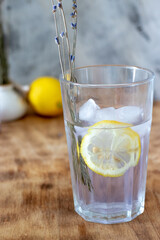 lavender lemonade with ice in a low glass glass stands on a table
