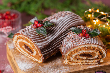 Traditional Christmas cake, chocolate Yule log with festive decorations 