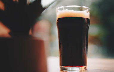 glass of fresh dark beer