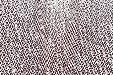 Abstract seamless white mesh fabric on black background.