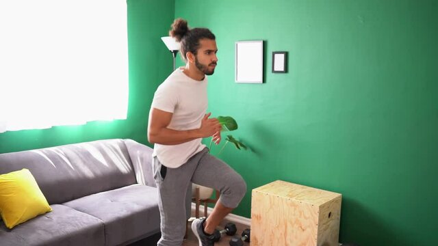 Active Young Man Doing Some HIIT Exercises At Home And Running In Place In Slow Motion