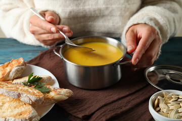 Concept of tasty eating with pumpkin soup, close up
