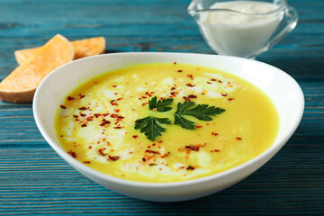 Concept of tasty food with pumpkin soup on wooden table