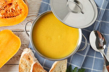 Concept of tasty food with pumpkin soup on wooden table