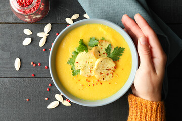 Concept of tasty eating with pumpkin soup on wooden table