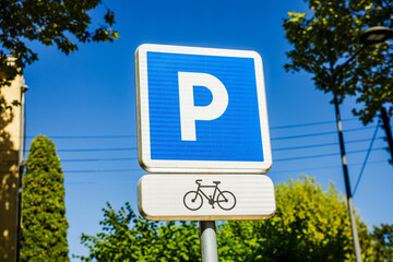 Blue sign designating bicycle parking lot - obrazy, fototapety, plakaty