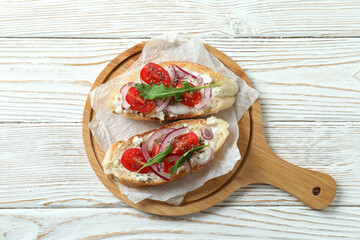 Concept of tasty food with bruschetta snacks on white wooden table