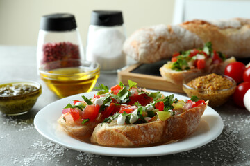 Concept of cooking bruschetta snacks on gray textured table