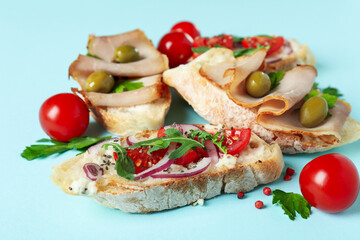 Fototapeta na wymiar Delicious italian snacks bruschetta on blue background